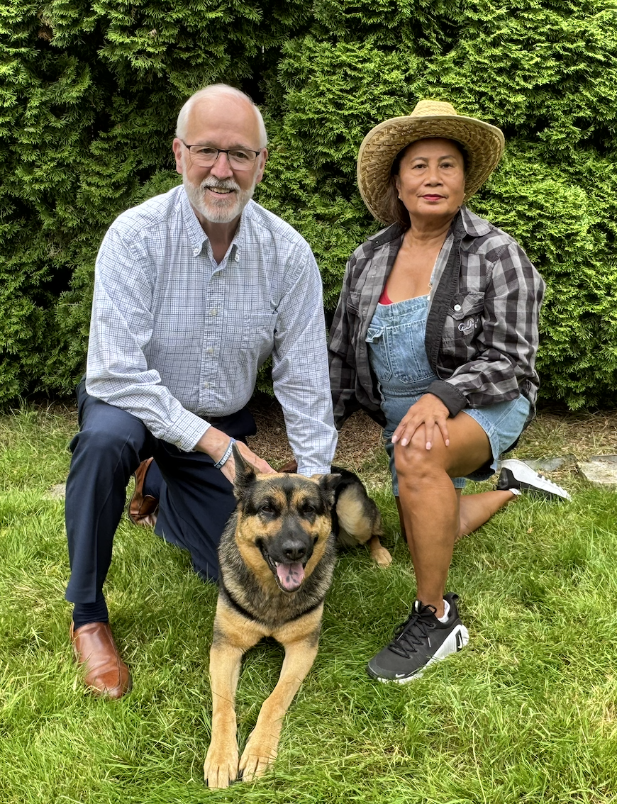 Michael Rutland with his wife and dog in a garden