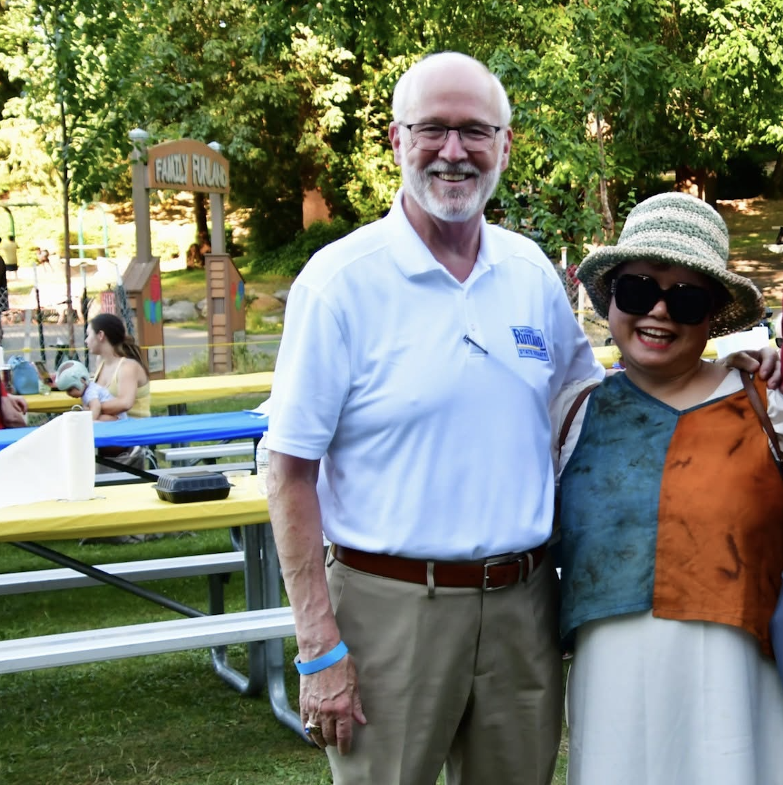 Michael Rutland posing with a supporter at a community event