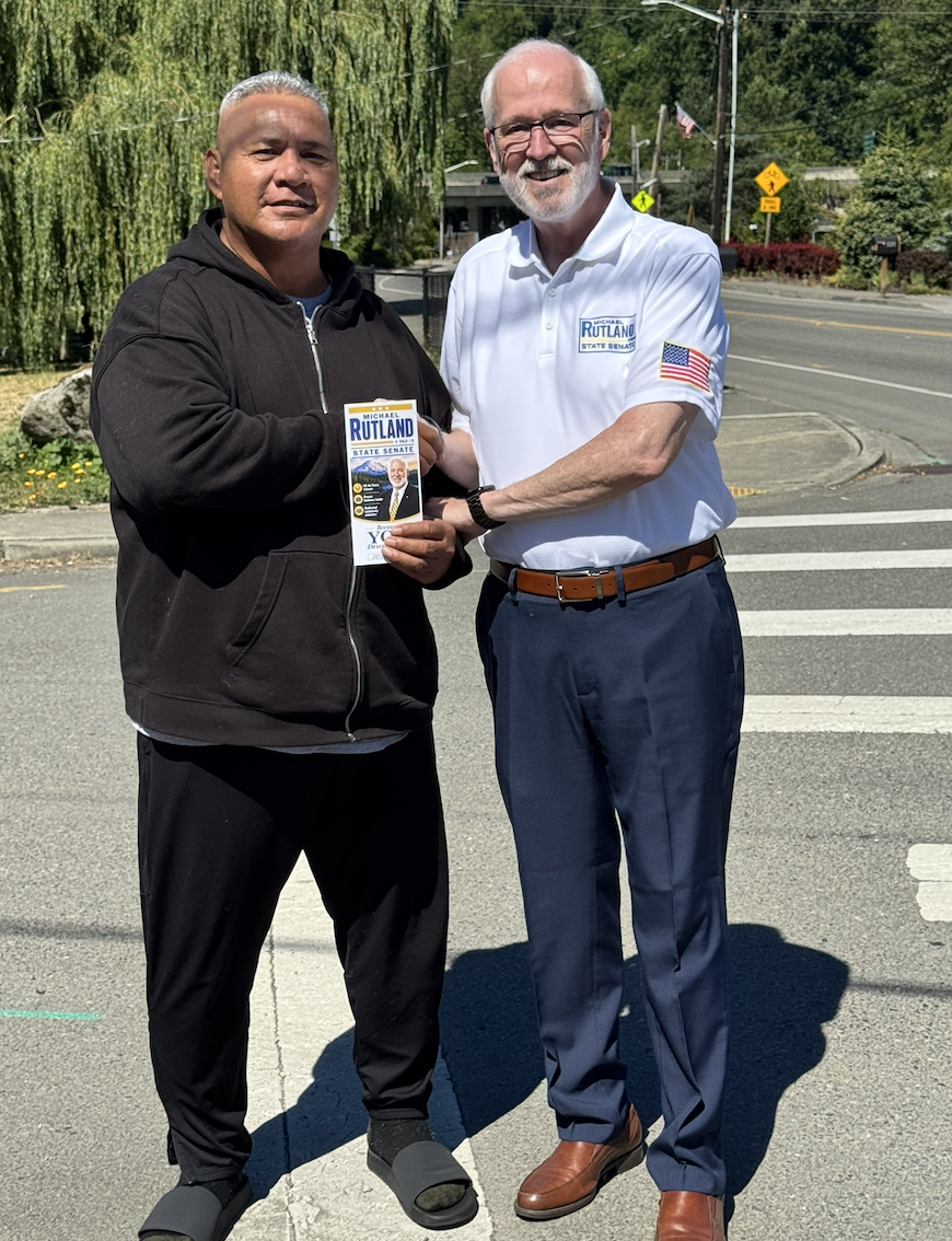 Michael Rutland meeting a voter while sharing campaign literature