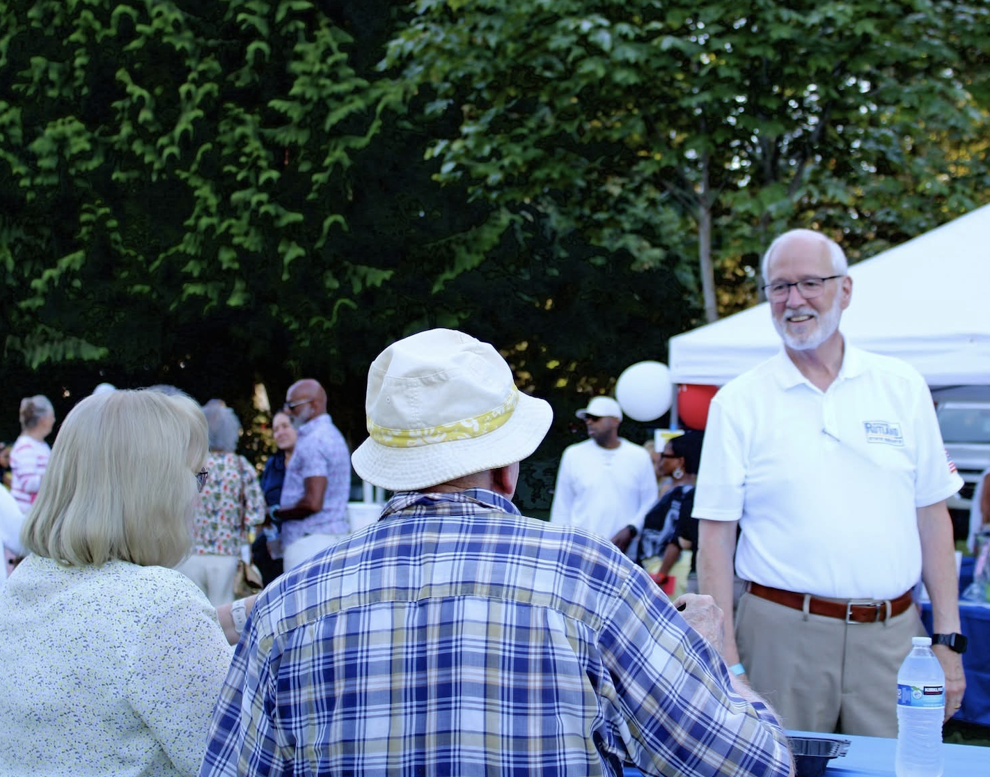 Michael Rutland greeting neighbors at a community gathering